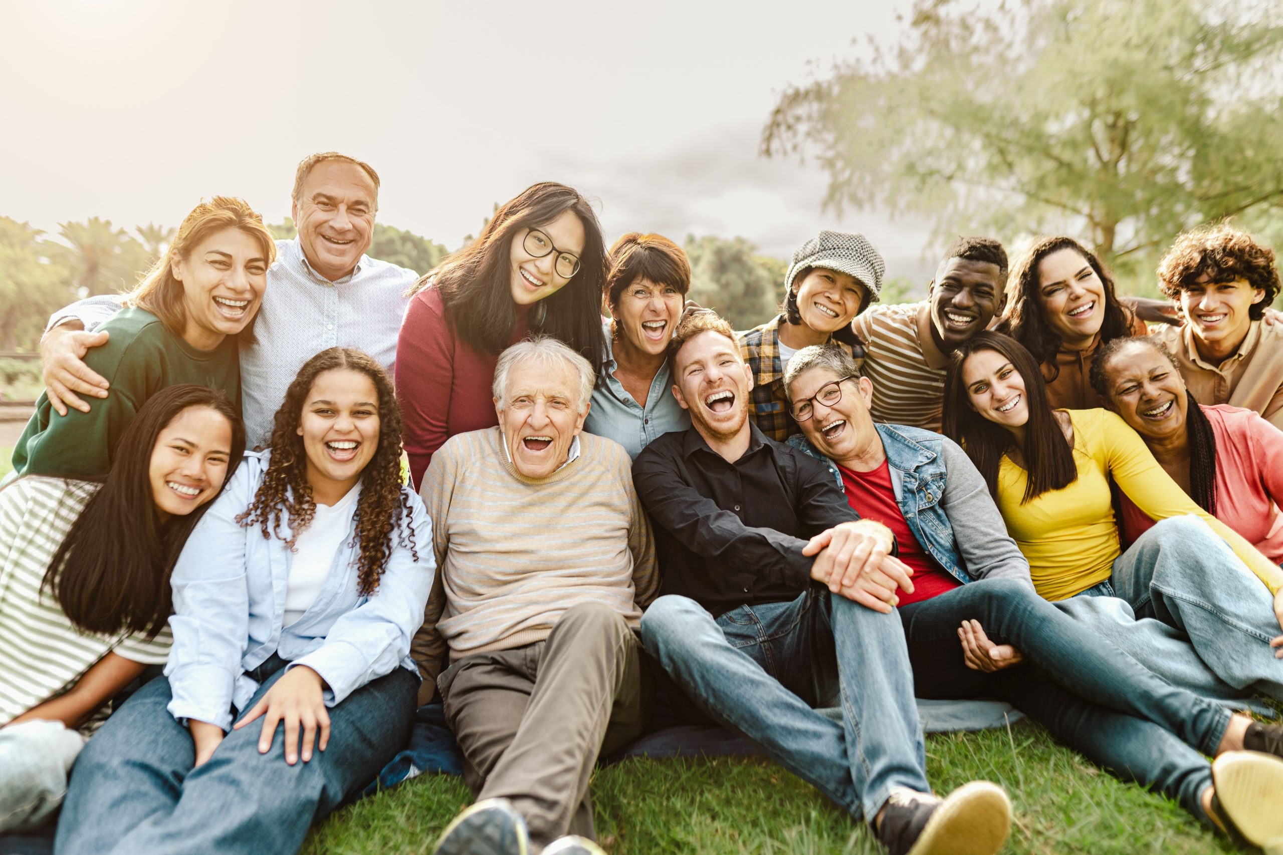 Happy,Multigenerational,People,Having,Fun,Sitting,On,Grass,In,A